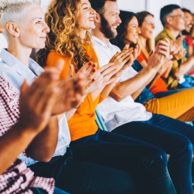 A crowd of people clap at an event supporting criminal justice diversion in Missouri.