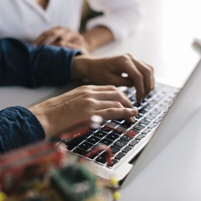A man types on his computer.